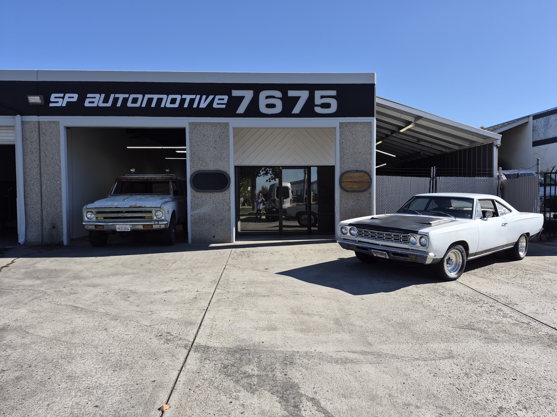 SP Automotive shop front with a classic Plymouth parked outside